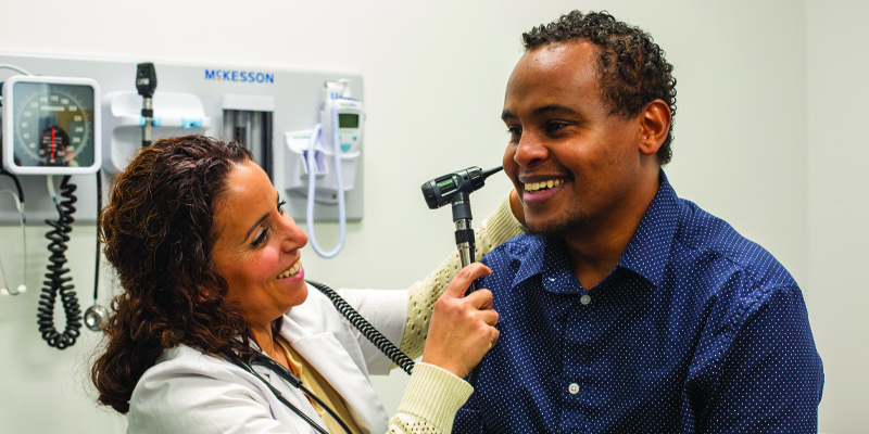nurse practitioner treating a patient 