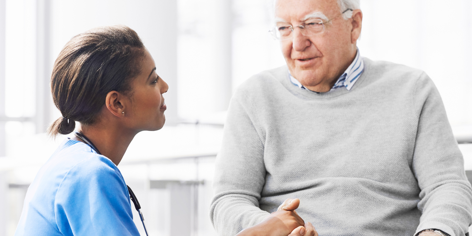 A doctor consults with an older adult patient. 